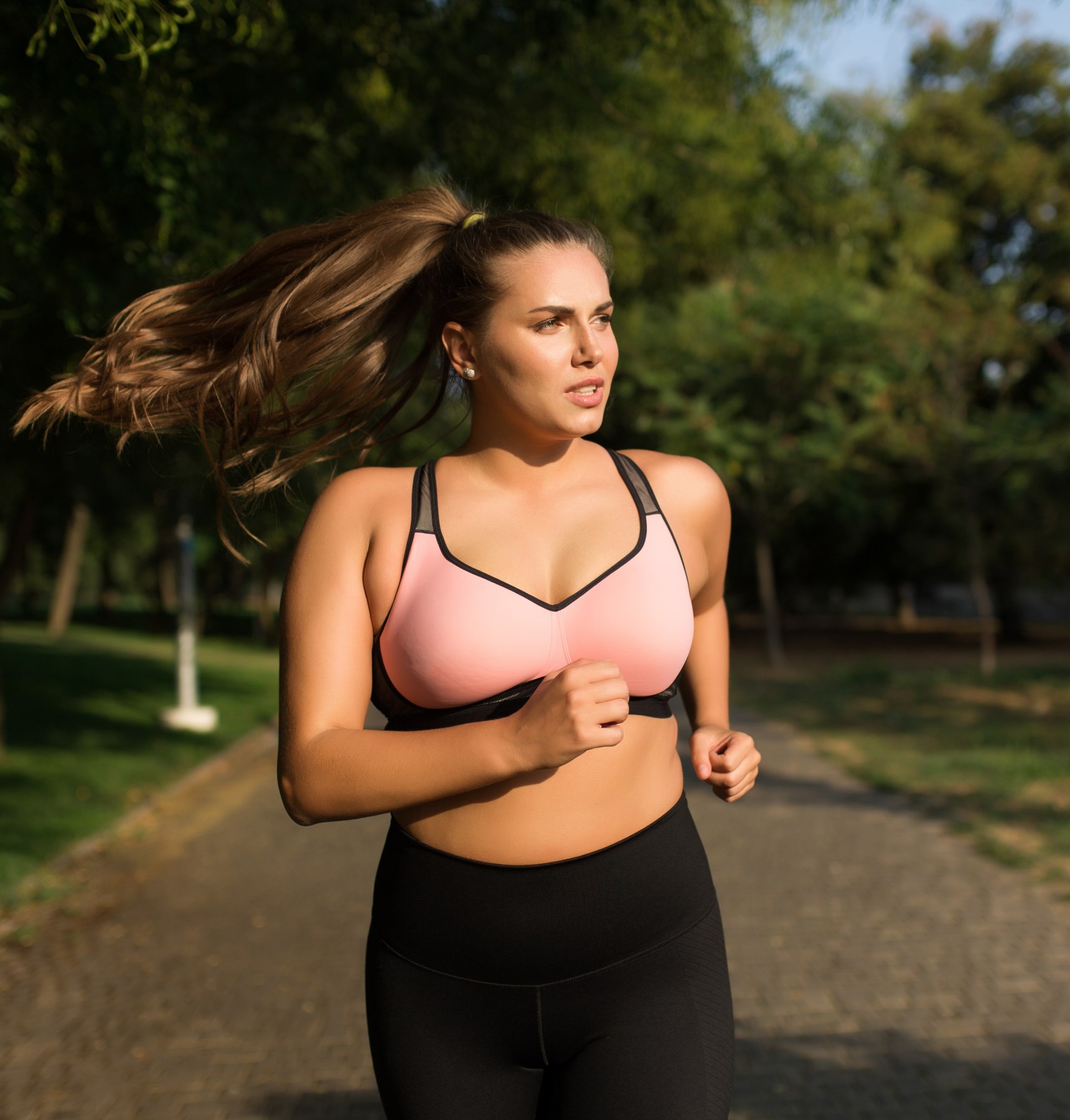 neck lift patient model with blonde hair touching her face at the beach